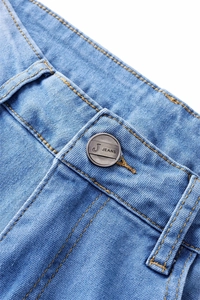 Macro detail of light blue denim jeans showing twill texture and metal button closure