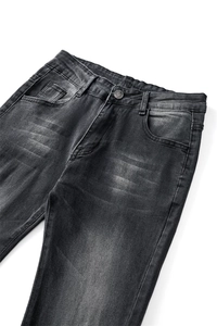 Detailed close-up of dark grey flared denim jeans featuring metal button and zip closure
