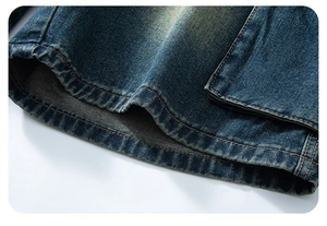 Dettaglio ravvicinato dell'orlo in denim blu scuro con doppia cucitura e lavaggio vintage