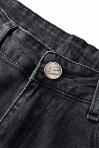 Close-up of metal button with embossed branding on dark grey stretch flared denim jeans