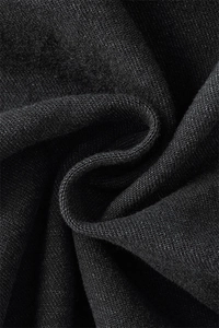 Detailed macro view showing the coarse woven texture and black fabric of denim jeans