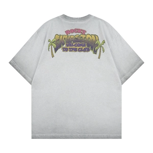 Detail of grey washed t-shirt featuring vintage rock graphics and palm tree print design