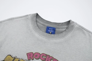 Detail of gray washed T-shirt showing retro rhinestone lettering and neck label