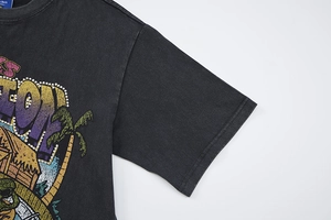 Detail of retro washed black T-shirt with vintage summer print and rhinestone accents
