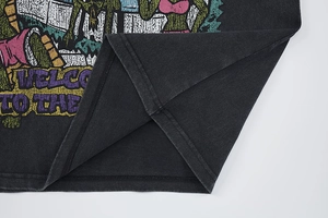 Detail of reinforced double-stitch hem on vintage washed charcoal grey cotton t-shirt