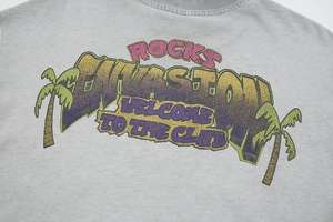 Close-up of vintage washed gray cotton t-shirt with colorful retro palm tree graphic print