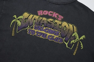 Detail of vintage washed black t-shirt with Rocks Invasion retro graphic print
