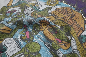 Detail of vintage cartoon alien print with rhinestones on gray washed cotton t-shirt