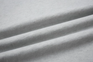 Macro shot of grey washed vintage t-shirt fabric showing soft cotton knit texture