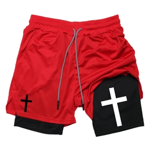 Detail of red mesh outer fabric and black compression layer of double-layer sports shorts