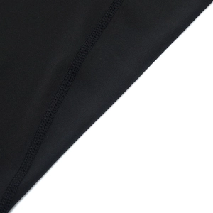 Detail view of black high-elasticity fabric with professional flatlock stitching for sportswear