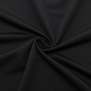 Macro shot of black compression shirt fabric with fine vertical texture and moisture-wicking weave