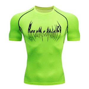 Detail of neon green compression gym shirt with black raglan seams and graphic print