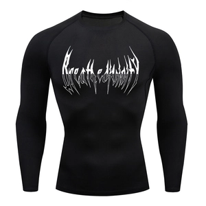 Close-up of black compression shirt with white artistic letter print and ergonomic stitching