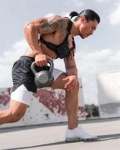 Action shot of men's athletic shorts with white inner layer during kettlebell workout