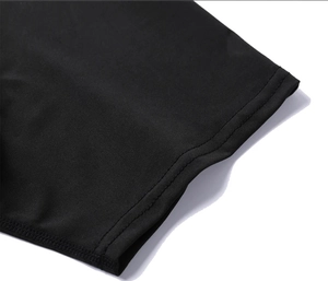 Detailed close-up of double-stitched hem and fabric texture on black athletic sports t-shirt