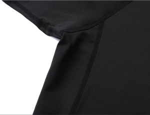 Detail showing flatlock seam and breathable fabric underarm area of the black sports suit