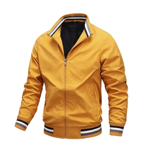 Detail of yellow casual jacket with black fleece lining and striped ribbed knit cuffs