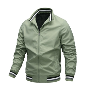 Detail of sage green bomber jacket showing ribbed cuffs and black fleece lining