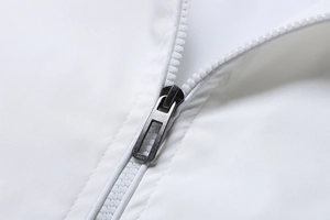 Detail of white sport jacket showing smooth polyester fabric and durable metal zipper slider