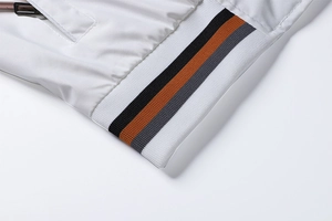 Detail of white casual jacket showing striped ribbed hem and zipper pocket closeup