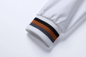 Close-up of elastic ribbed jacket cuff with orange, black and grey stripes details