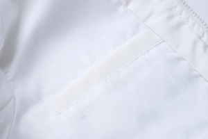 Detail view of a white casual jacket featuring side pocket stitching and zipper edge