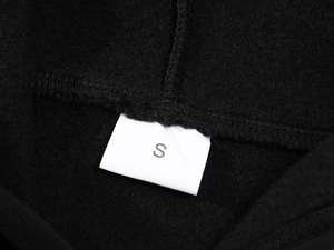 Close-up of the soft black fleece interior lining and size S tag on the hoodie