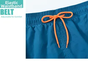 Detail of blue swim shorts featuring an elastic waistband and bright orange drawstring