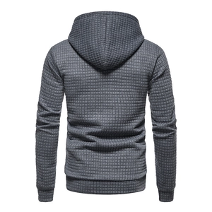 Detail view of men's dark grey hoodie back with waffle knit texture and ribbed hemline