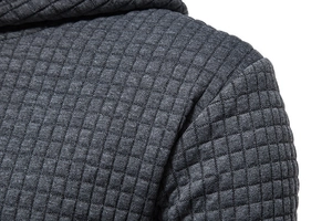 Macro shot of the dark grey hoodie showing detailed 3D square check texture and knit fabric