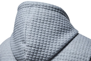 Detail shot of men's grey hoodie featuring premium waffle texture and square quilting