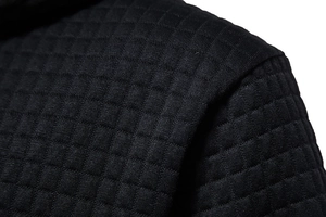 Macro shot of waffle textured stitching and shoulder seam detail on black hoodie