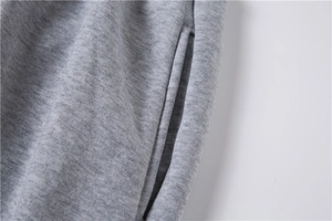 Detail view of heather grey sweatpants featuring a side seam pocket and knit texture