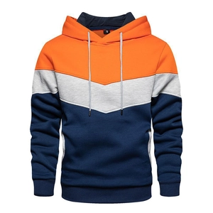 Detailed close-up of a men's three-color V-shape patchwork hoodie with ribbed cuffs