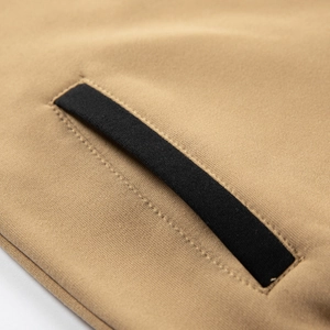 Detailed close-up of pocket stitching on the camel hoodie with black contrast trim