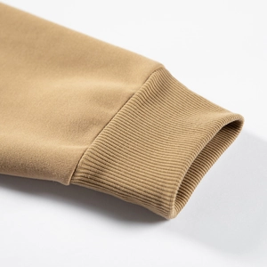 Detail view of khaki rib-knit cuffs on a long-sleeve hoodie showing texture