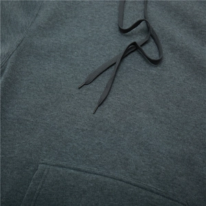 Close-up of charcoal grey hoodie featuring flat black drawstrings and kangaroo pocket seams