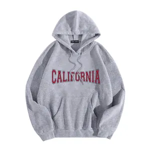 Detail of oversized gray hoodie with red California lettering and kangaroo pocket