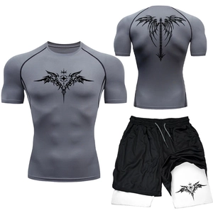 Close-up of men's MMA compression set with tribal wing pattern and dual-layer gym shorts