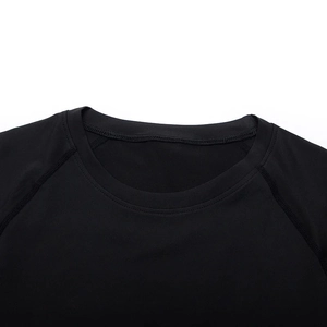 Detail of black raglan sleeve stitching and round neck on quick dry compression shirt
