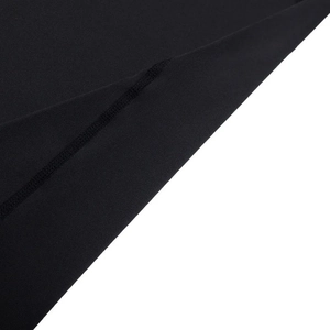 Detailed close-up showing flatlock stitching on black compression sports fabric