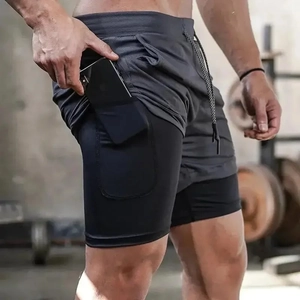 Close-up of men's 2-in-1 dark grey gym shorts featuring a built-in phone pocket