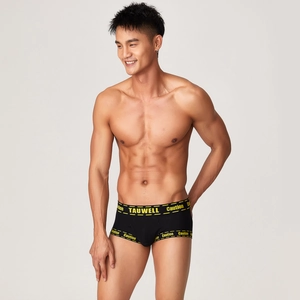 Detail of black men's boxer briefs with yellow Caution industrial print on the waistband