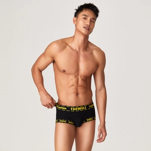 Detail of men's low rise boxer briefs with yellow caution tape pattern and industrial design
