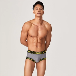 Detail of men's grey ribbed boxer shorts featuring a branded caution lettered waistband