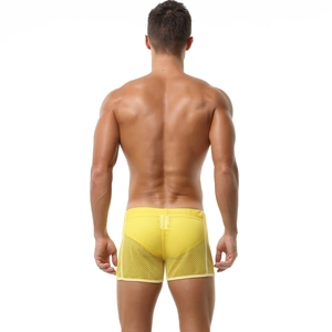 Detail of men's yellow mesh boxer shorts featuring breathable hollowed-out fabric texture