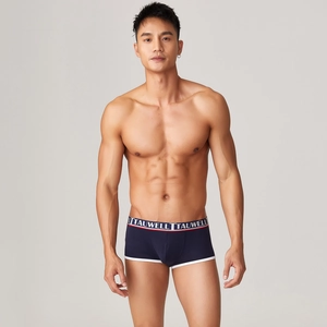 Detail of navy modal boxer briefs featuring a wide elastic waistband and contrast piping