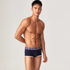 Detail view of navy modal boxer briefs with tri-color elastic waistband and white piping trim