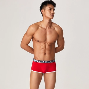 Close-up of red modal boxer briefs featuring a black elastic waistband and white trim details